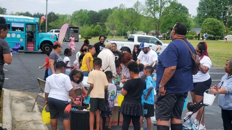 Children and families gathered at an activity table on Community Day
