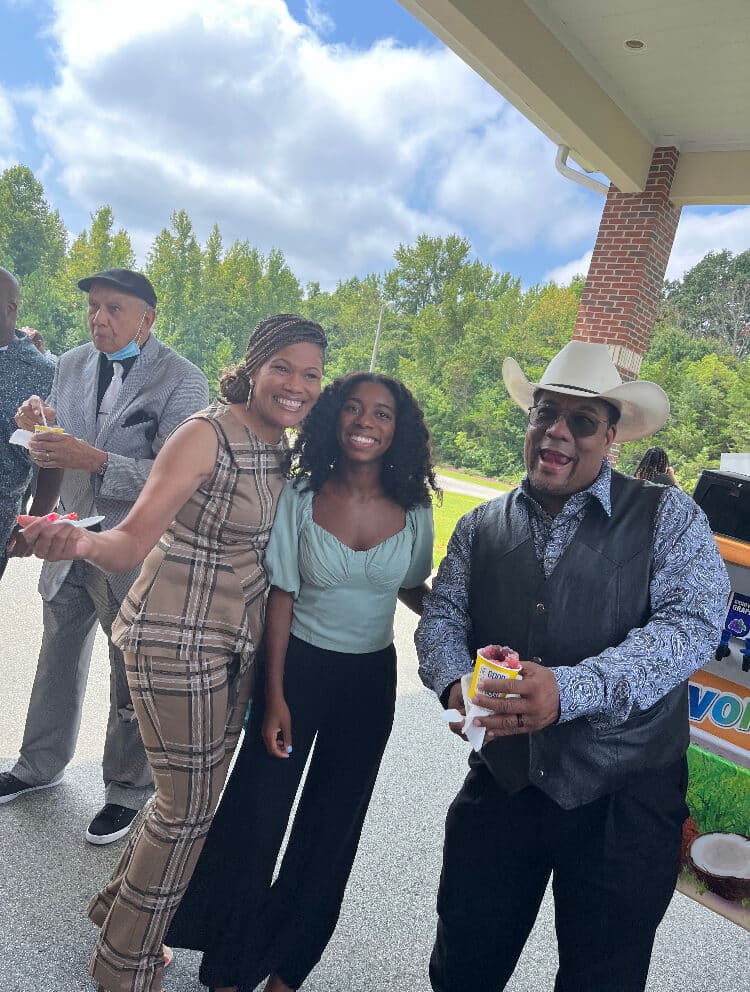 Guests enjoying snow cones together under the church portico