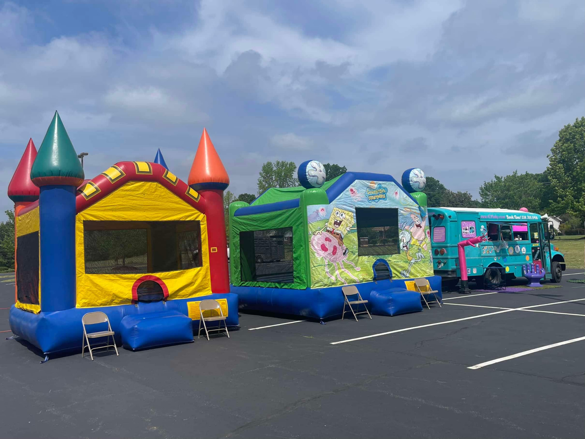 Bounce houses and an ice cream truck set up in the church parking lot